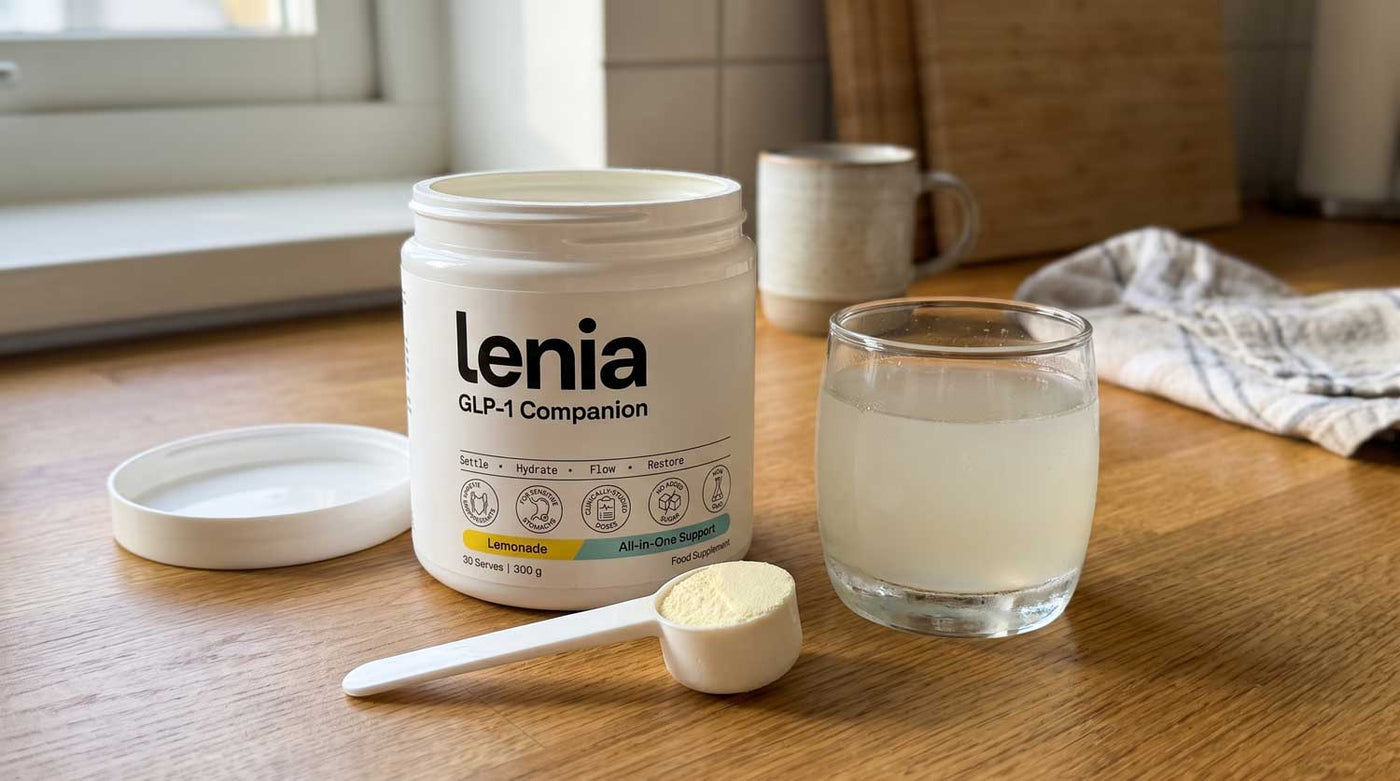 Lenia tub beside a glass of light lemonade on a kitchen counter